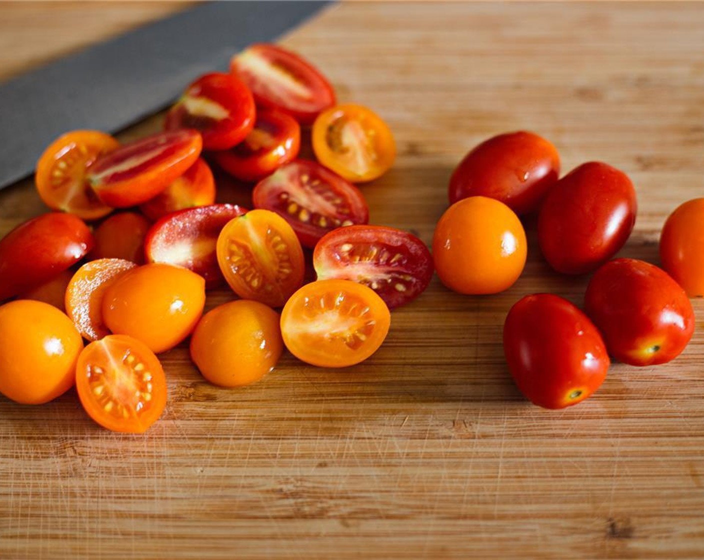 step 6 While your maize meal is cooking, get started on the relish by halving Cherry Tomatoes (4 cups).