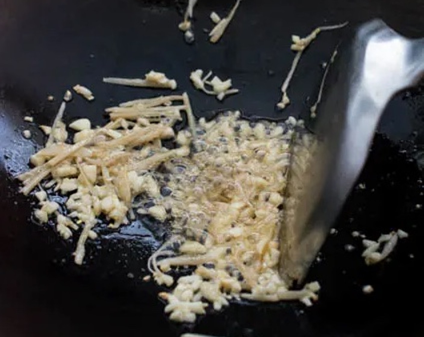 step 3 Heat Cooking Oil (2 Tbsp) and Sesame Oil (1 Tbsp) in a wok over medium-high heat. Add the Fresh Ginger (2 Tbsp) and Garlic (3 cloves) to the wok while the oil is heating up so that the flavors are infused in the oil. Saute until aromatic for about 1 minute.