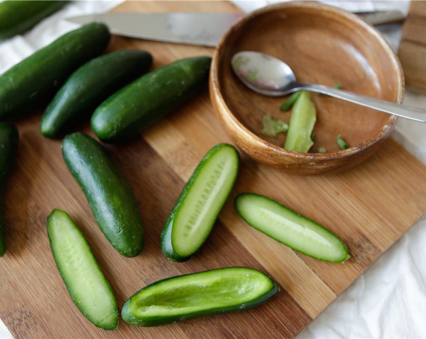 step 2 Wash and dry Baby Cucumbers (20). Slice the top of the cucumber off lengthways and remove the seeds (save them for juicing or a salad).
