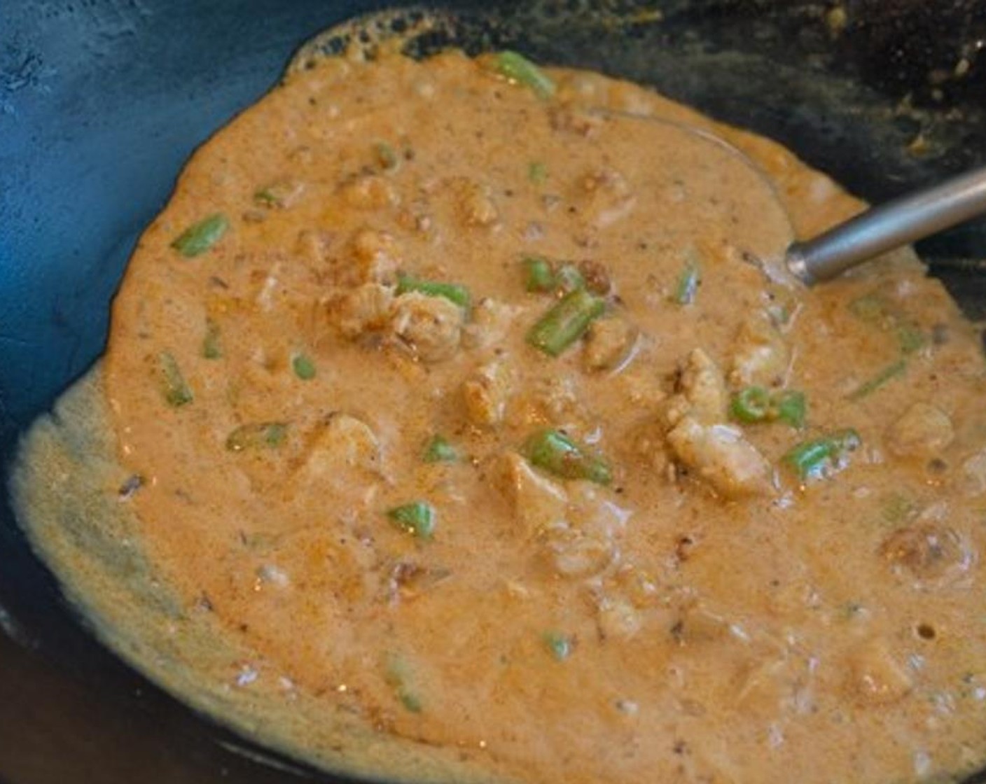 step 9 Add Coconut Milk (1 1/2 cups) and stir often. Don't forget to scrape the bottom of the wok or pan to keep the curry from burning. It will thicken up quickly! Keep stirring until all of the ingredients are well incorporated and the curry starts to simmer.