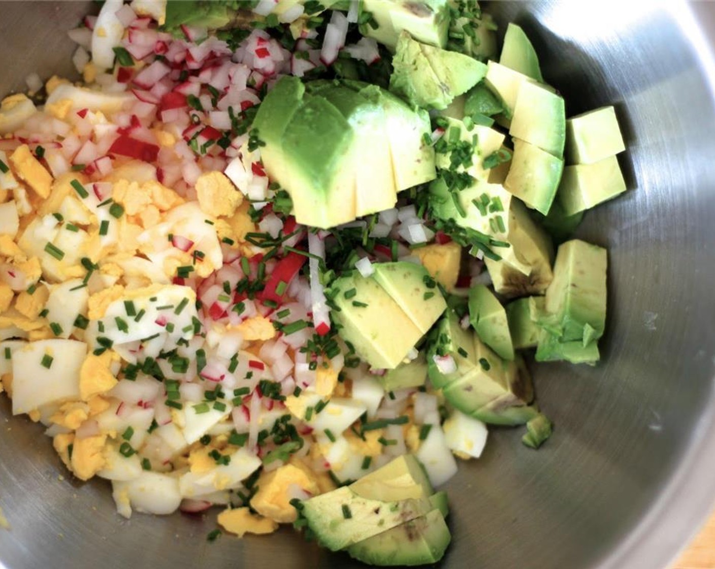 step 2 In a bowl, mix the eggs, Fennel Bulb (1/4)m Radish (1/4 cup), Fresh Chives (1/4 cup), and Avocado (1).