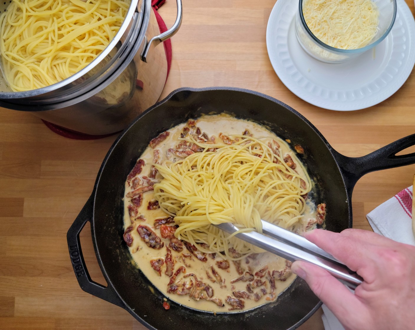 step 12 Using tongs, add the spaghetti, and the remaining Shredded Parmesan Cheese (3/4 cup) to the saucepan. Top the spaghetti with the chicken and spoon any additional sauce on top of the chicken. Serve with Garlic Bread (1 lb).