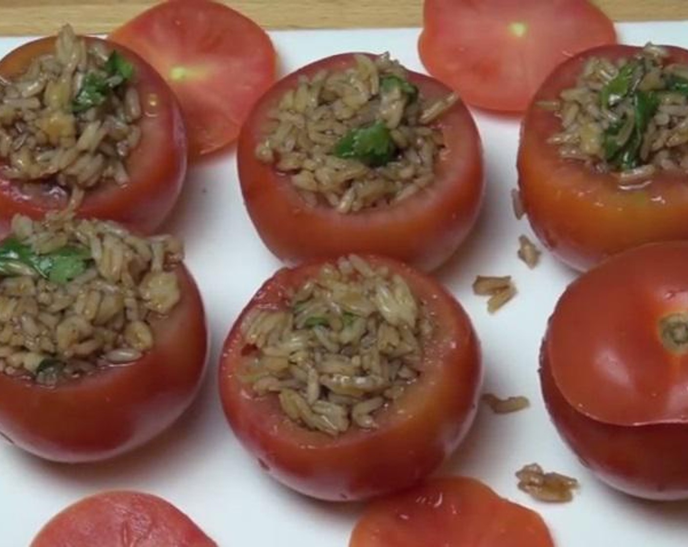 step 2 Take each Tomatoes (6), and cut off a thin slice from the top. Using a spoon, scoop out the seeds from the center. Fill in each empty tomato with the rice mixture you made.