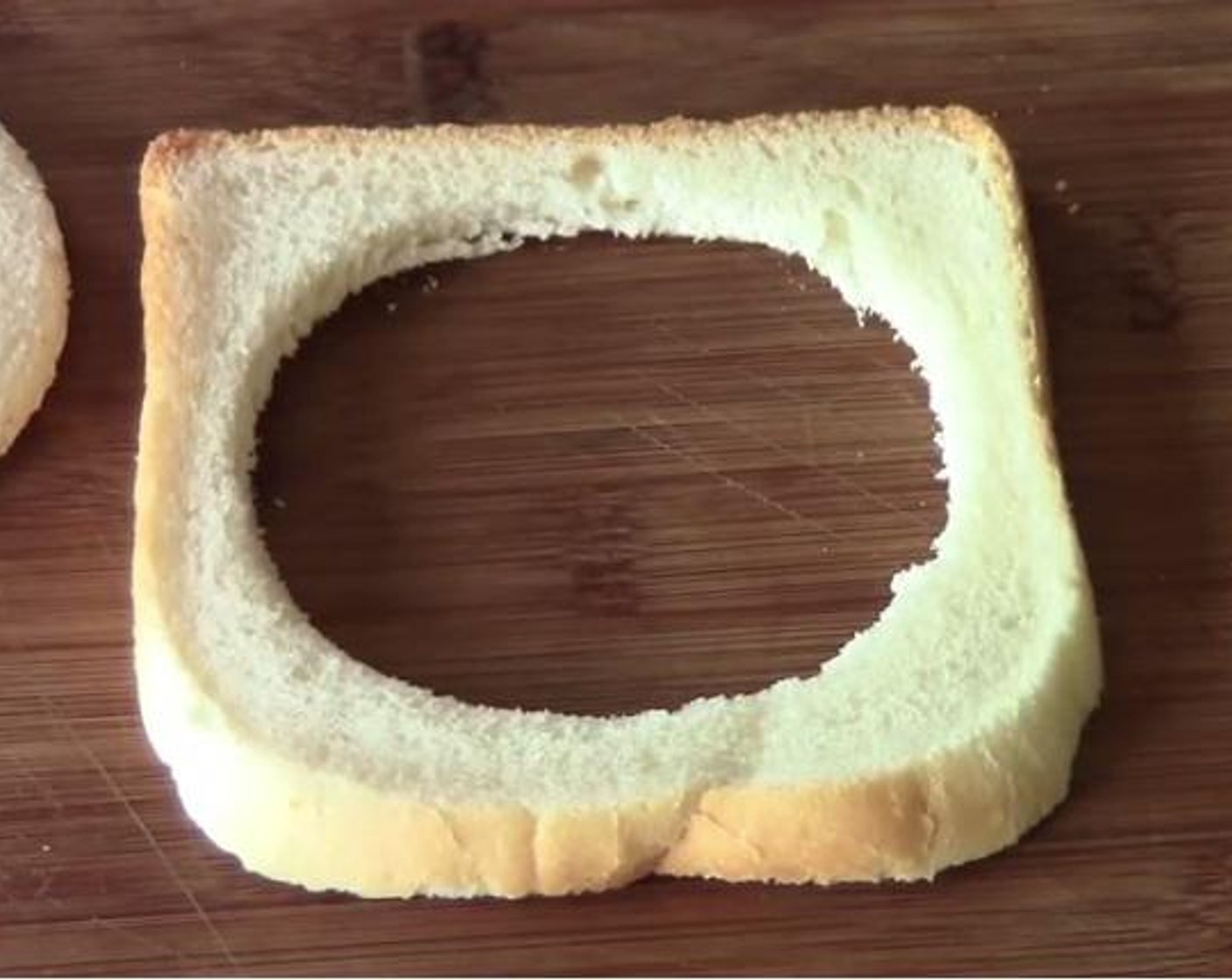 step 1 Using a cookie cutter, cut a hole at the center of the Bread (1 slice). Crack the Egg (1) into a cup.