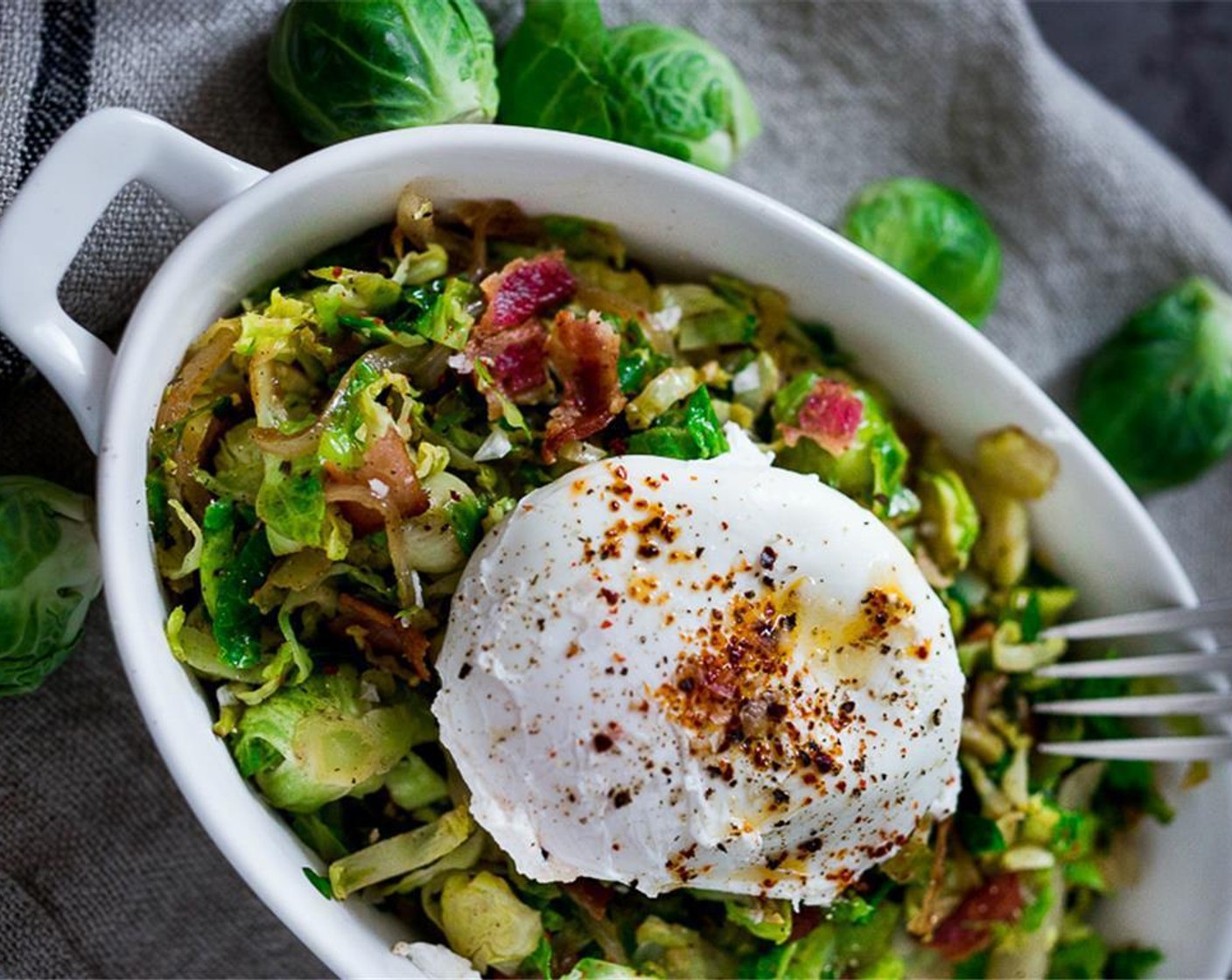 step 6 Divide Brussels sprout hash among 3-4 bowls. Top with eggs. Sprinkle eggs with Finishing Salt (to taste), Freshly Ground Black Pepper (to taste) and Aleppo Pepper (1 pinch) or chili flakes. Serve immediately.