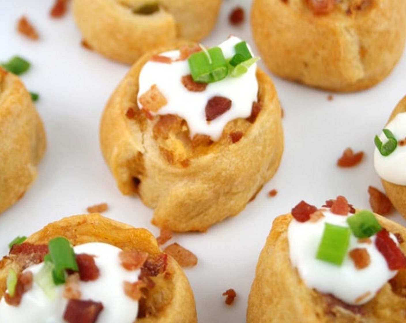 step 8 Bake 17 to 21 minutes or until golden brown. Immediately, remove from cookie sheets to serving plate. Top each pinwheel with Sour Cream (1/3 cup), remaining Bacon Bits (2 1/2 Tbsp) and finely chopped Scallions (2 Tbsp).