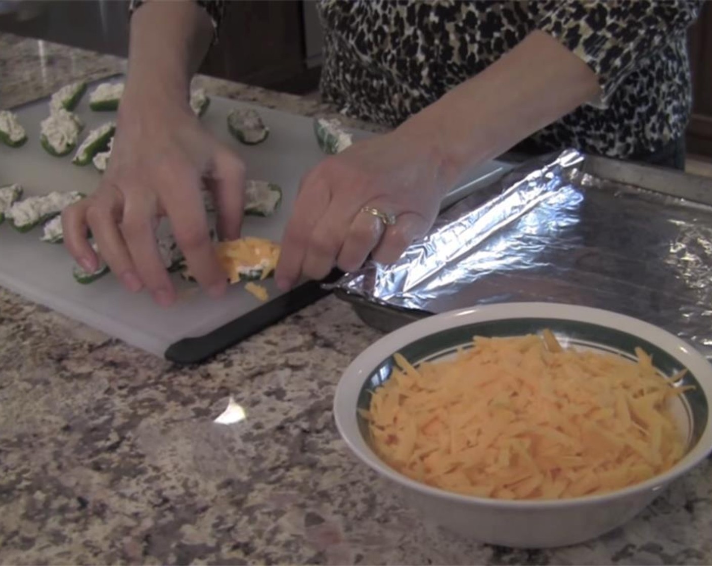 step 6 Push the cheese into the cream cheese mixture so it sticks. Place onto the cookie sheet, and repeat with the rest of the peppers.