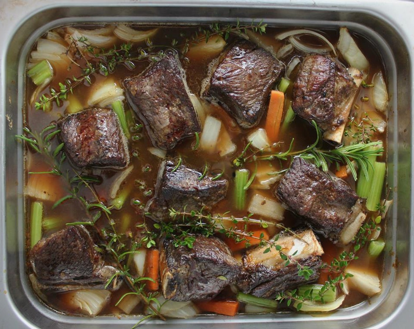 step 4 Add in the Fresh Thyme (5 sprigs), Fresh Rosemary (3 sprigs), and Beef Stock (4 cups). The stock should cover about two thirds of the ribs. Cover with tin foil and place in the oven to braise for 5 hours.