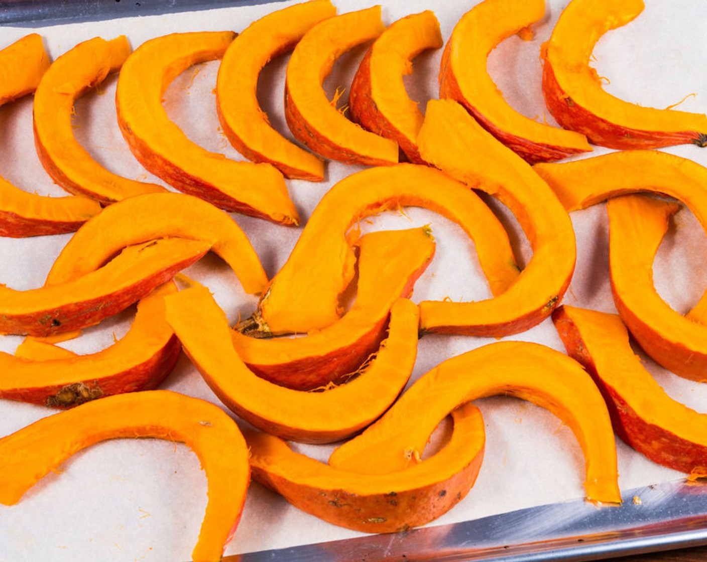 step 3 Transfer the slices onto a baking sheet lined with parchment paper. Drizzle the pumpkin with Extra-Virgin Olive Oil (2 Tbsp) and rub it on both sides.