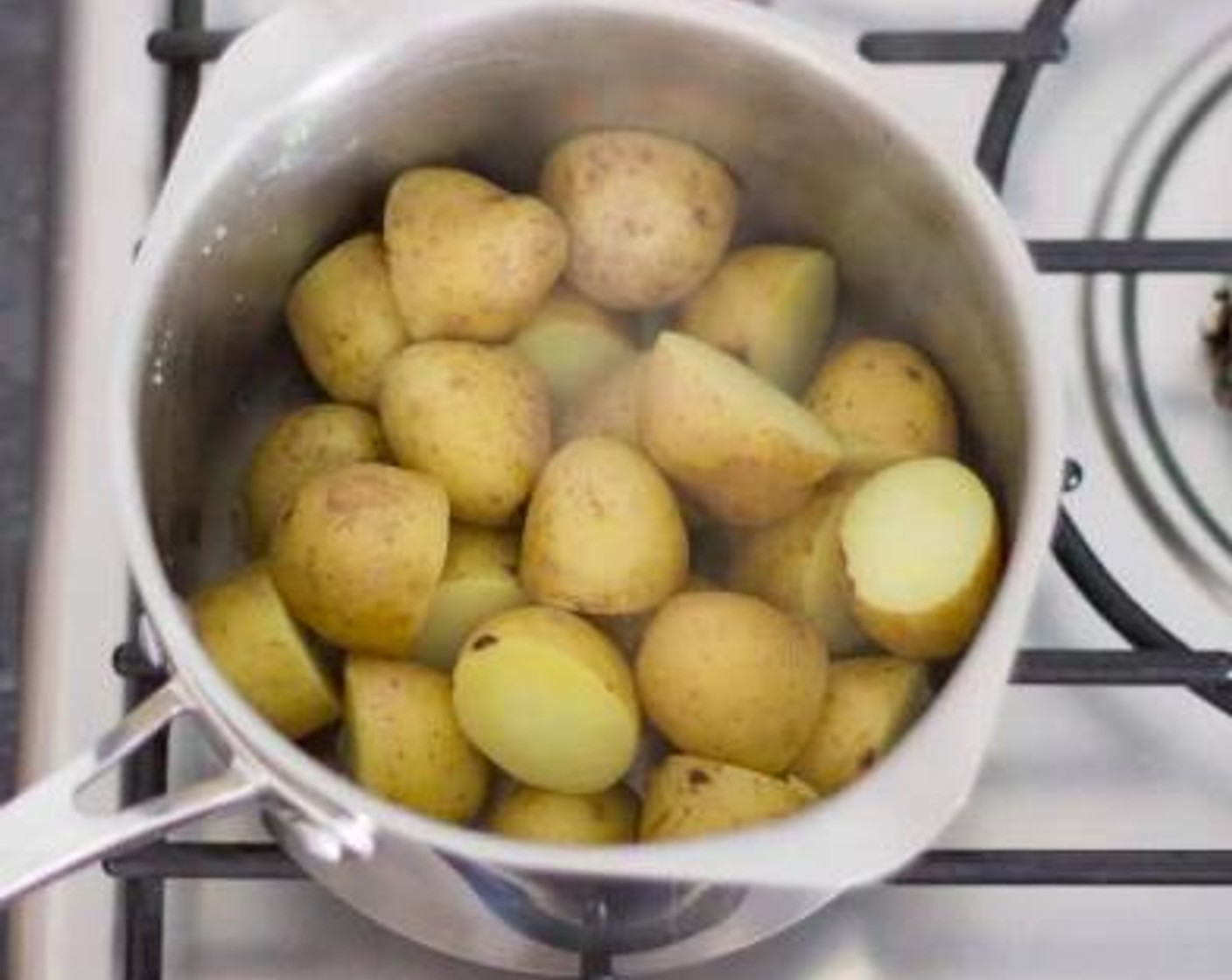 step 1 Put the New Potatoes (4 1/3 cups) into a medium saucepan and cover with cold water. Sprinkle in a generous helping of Salt (to taste) then set the pan over a high heat and bring up to the boil.