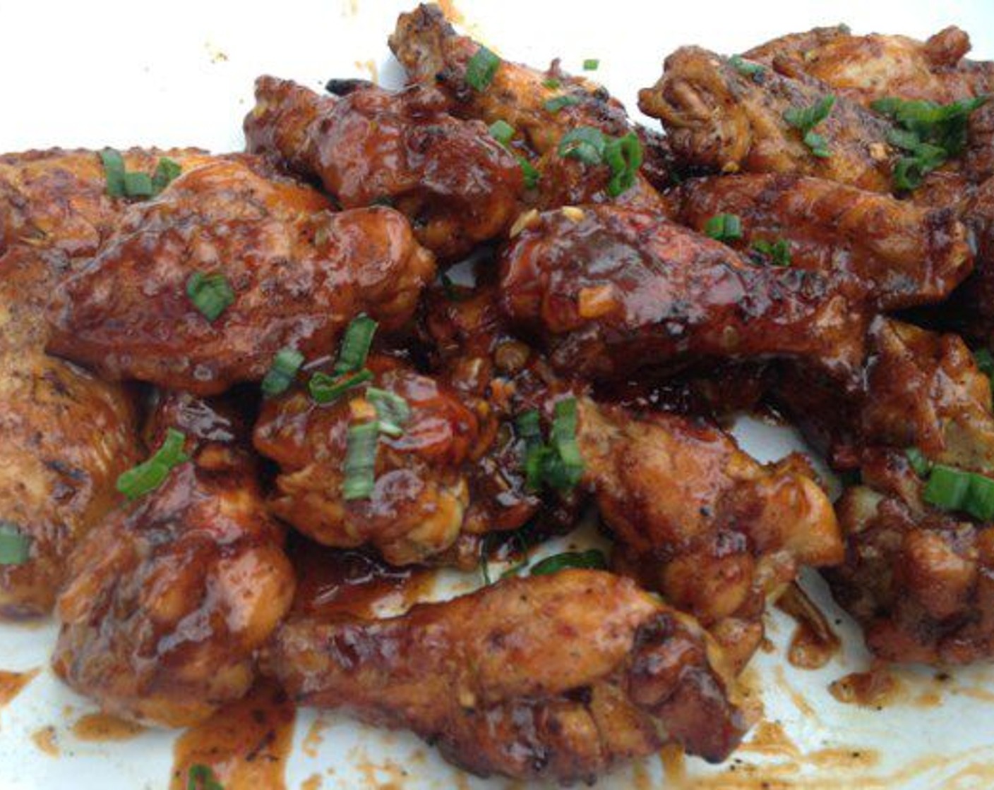 step 9 Now that the wings are grilled, it’s time to toss them in the sauce. Use a large bowl and work in batches. It doesn’t take a lot of sauce to coat the wings. Place a few wings in the bowl and pour a little sauce on top. Toss them around and let the sauce coat the wings. When all of the wings are tossed in the sauce, you’re done. Serve and Enjoy.