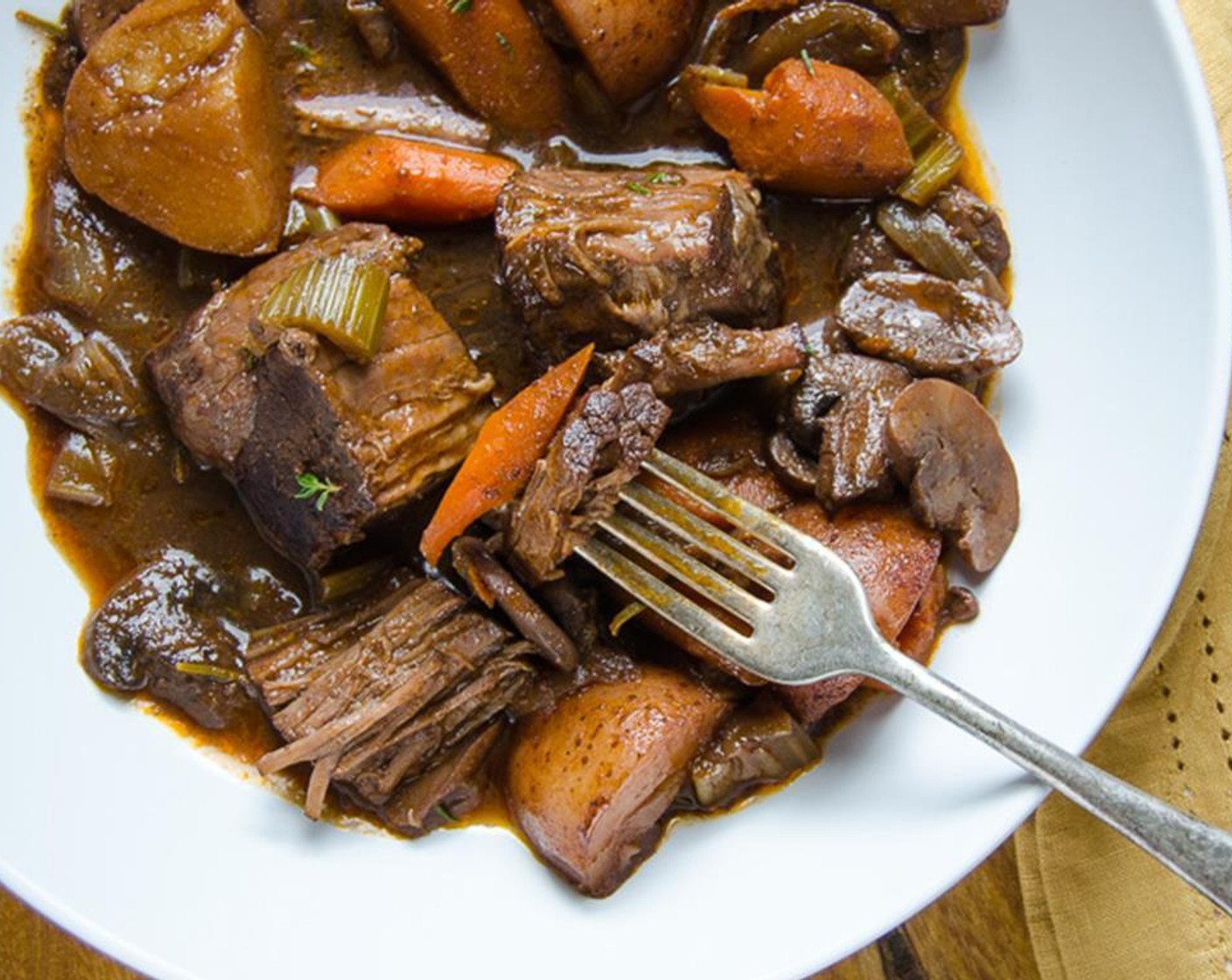 step 10 Transfer the dutch oven pot roast to a serving platter. Stir the porcini sauce and vegetables to combine and pour over the Yankee Pot Roast. Serve.