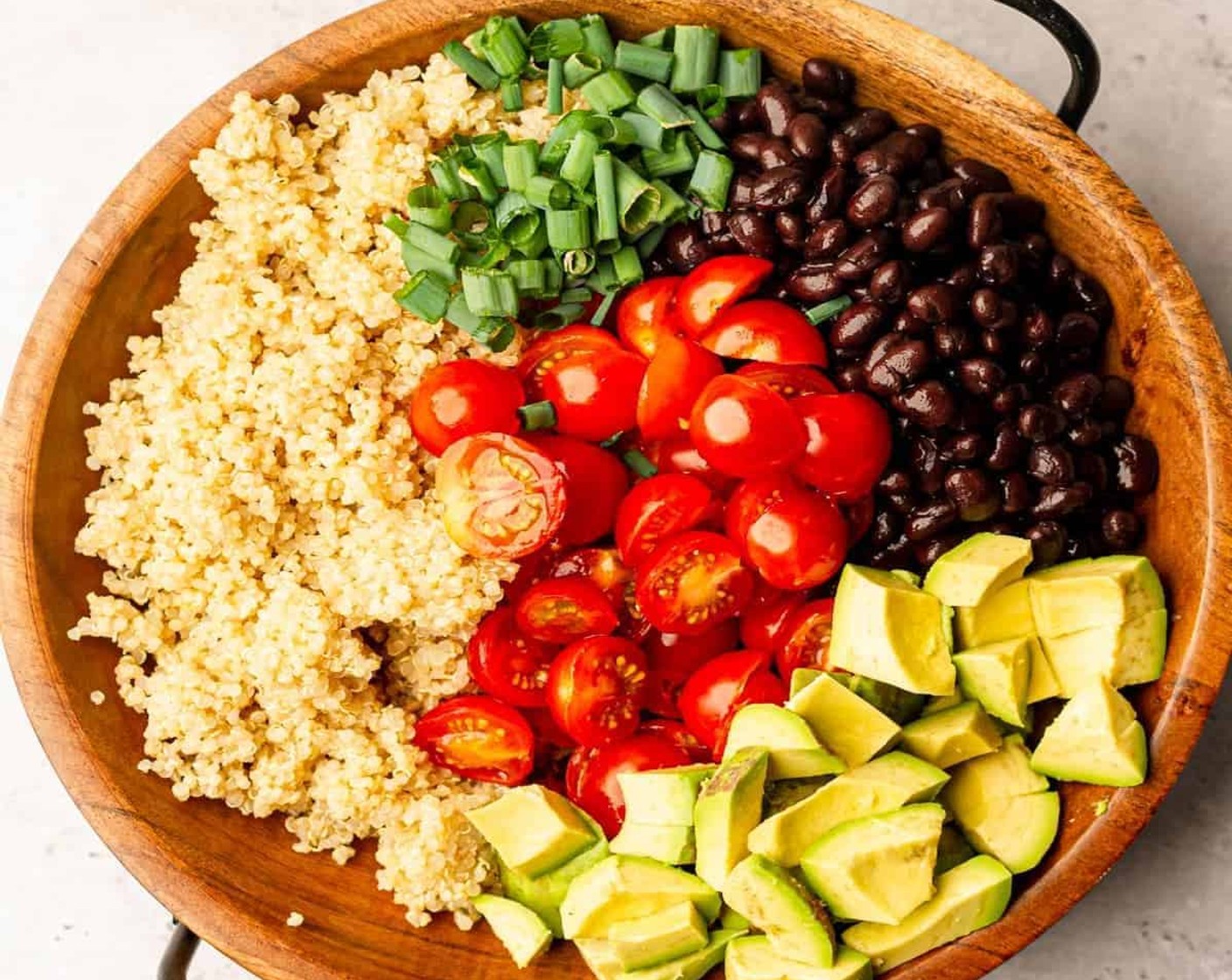 step 1 In a large bowl, add the Quinoa (3 cups), Black Beans (1 can), Cherry Tomatoes (2 cups), Avocado (1), and Scallion (1/4 cup).