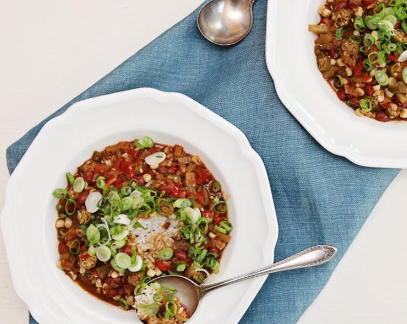 step 12 Fluff the rice with a fork, and divide between 2 plates or pasta bowls. Spoon the gumbo over the rice, and top with chopped spring onion. Serve and enjoy!