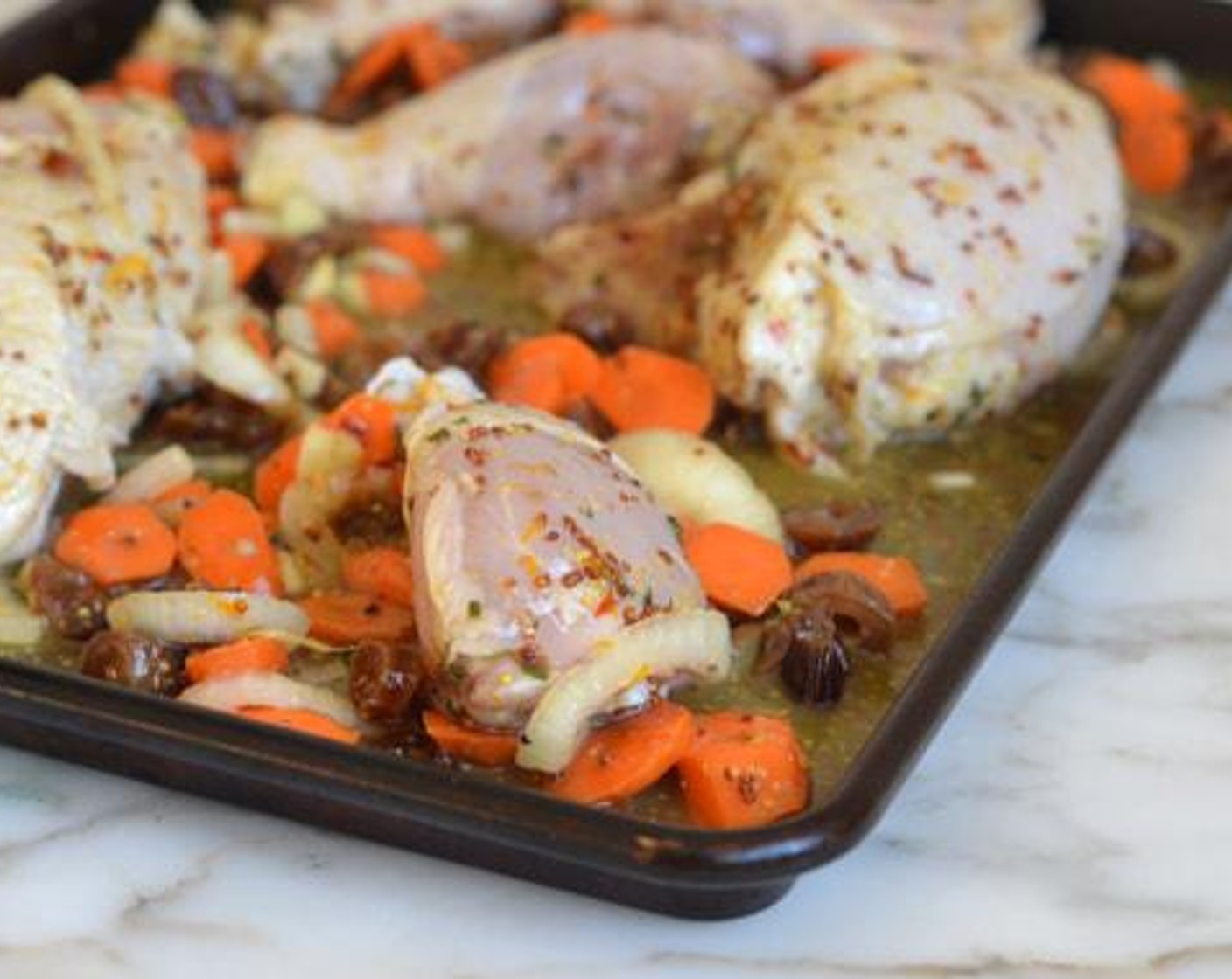 step 6 Transfer all the ingredients from the bag, including the marinade, to a rimmed sheet pan. Turn the chicken skin side up. Roast until chicken is lightly browned and cooked through, 40-45 minutes. Halfway through cooking, stir the carrots.