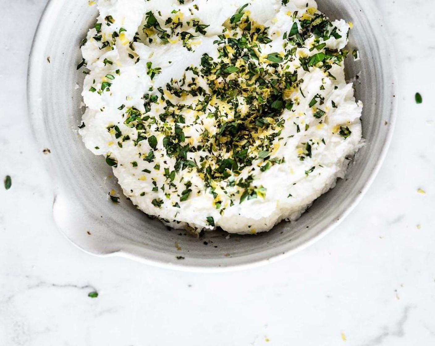 step 3 In a small bowl, combine the Labneh Cheese (2 cups) with the Salt, Fresh Basil (2 Tbsp), Fresh Mint (1 Tbsp), Fresh Thyme Leaves (1 tsp) and Lemon Zest, reserving a bit of the zest for garnish. Mix until well combined, set aside.