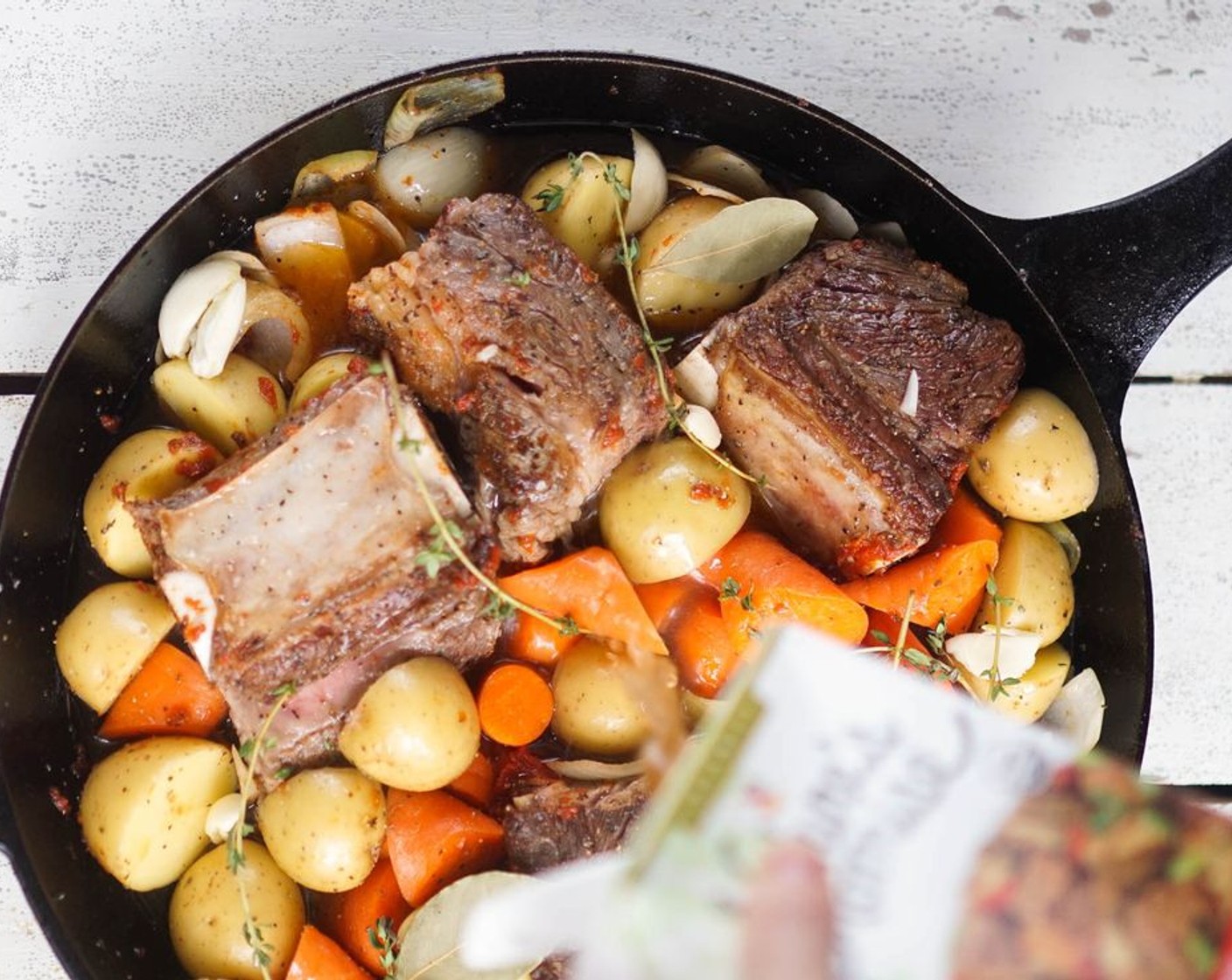 step 6 Add Low-Sodium Beef Broth (2 cups) until the vegetables and short ribs are just about, but not fully, submerged. Add the Fresh Thyme (3 sprigs) and Bay Leaves (2). Bring to a boil and boil for 2 minutes.
