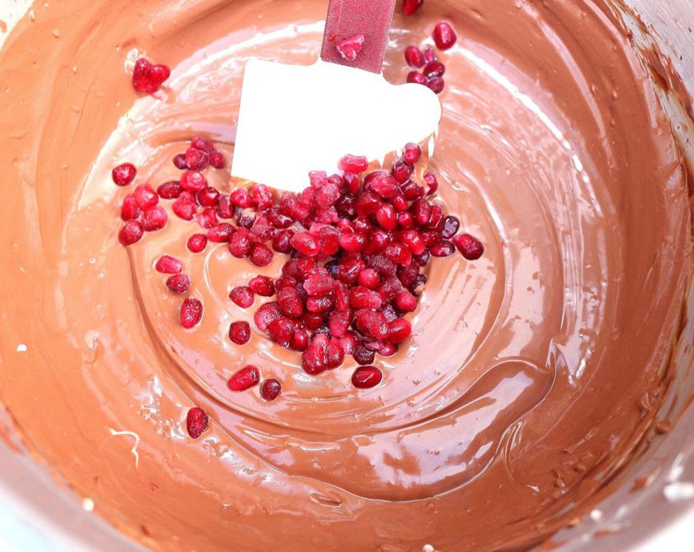 step 4 Fold the yogurt into the chocolate mixture using a spatula until thoroughly combined, then stir in the Honey (1 Tbsp), Grand Marnier (2 Tbsp), Orange Marmalade (3 Tbsp) and Pomegranate Seeds (1/2 cup).