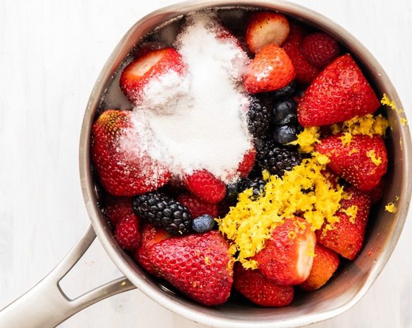step 1 In a medium saucepot, mix together Fresh Strawberries (1 1/2 cups), Fresh Blueberries (2 cups), and Fresh Blackberries (2 cups). Add Granulated Sugar (1/2 cup), Lemon (1), and a squeeze of fresh lemon juice. Stir together to evenly coat the berries in sugar.