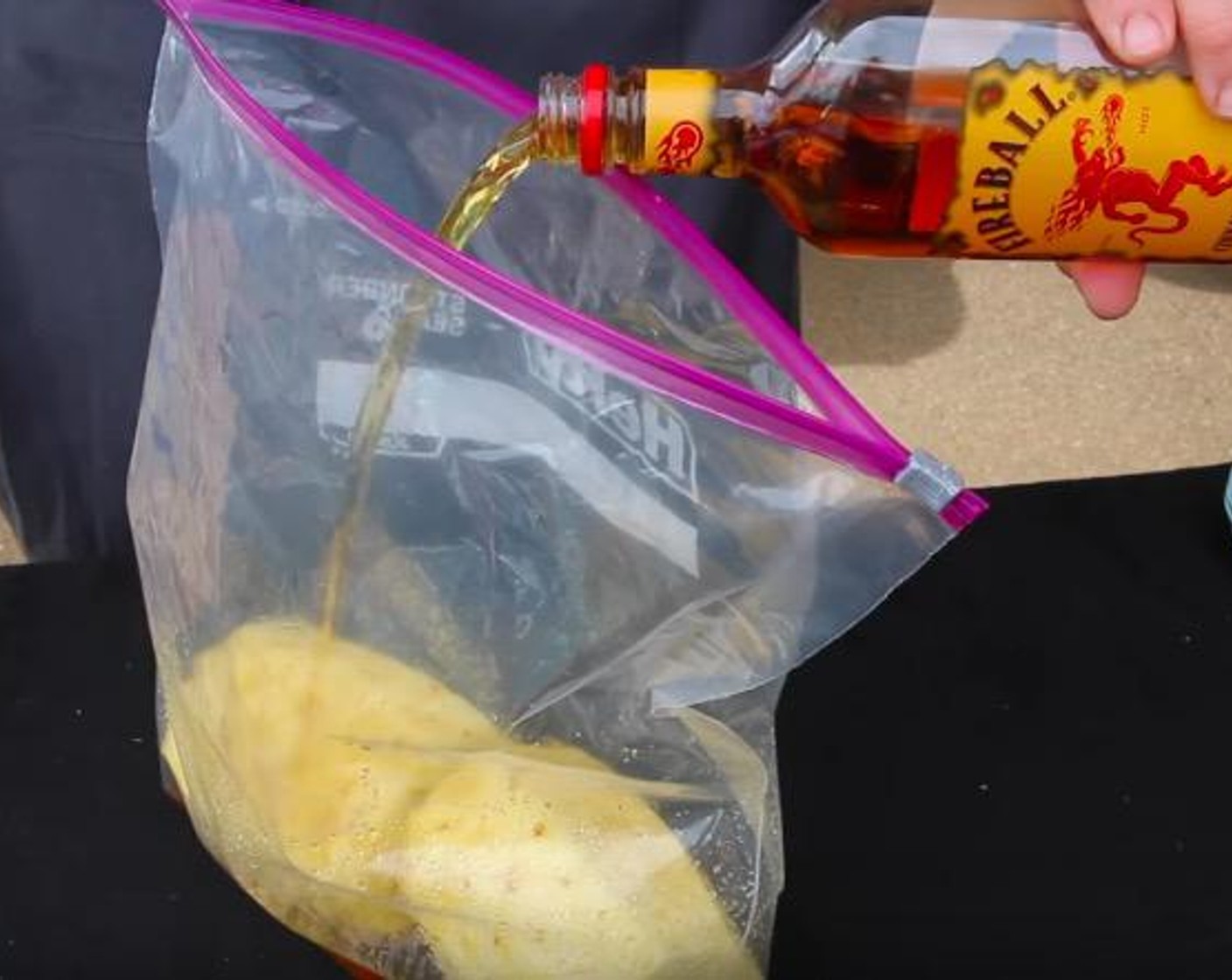 step 2 Place both pineapples in a ziplock storage bag and pour in the Fireball Whiskey (12 fl oz). Close the bag and squeeze as much air out as possible. Marinate for at least 2 hours in the refrigerator, turning halfway through.