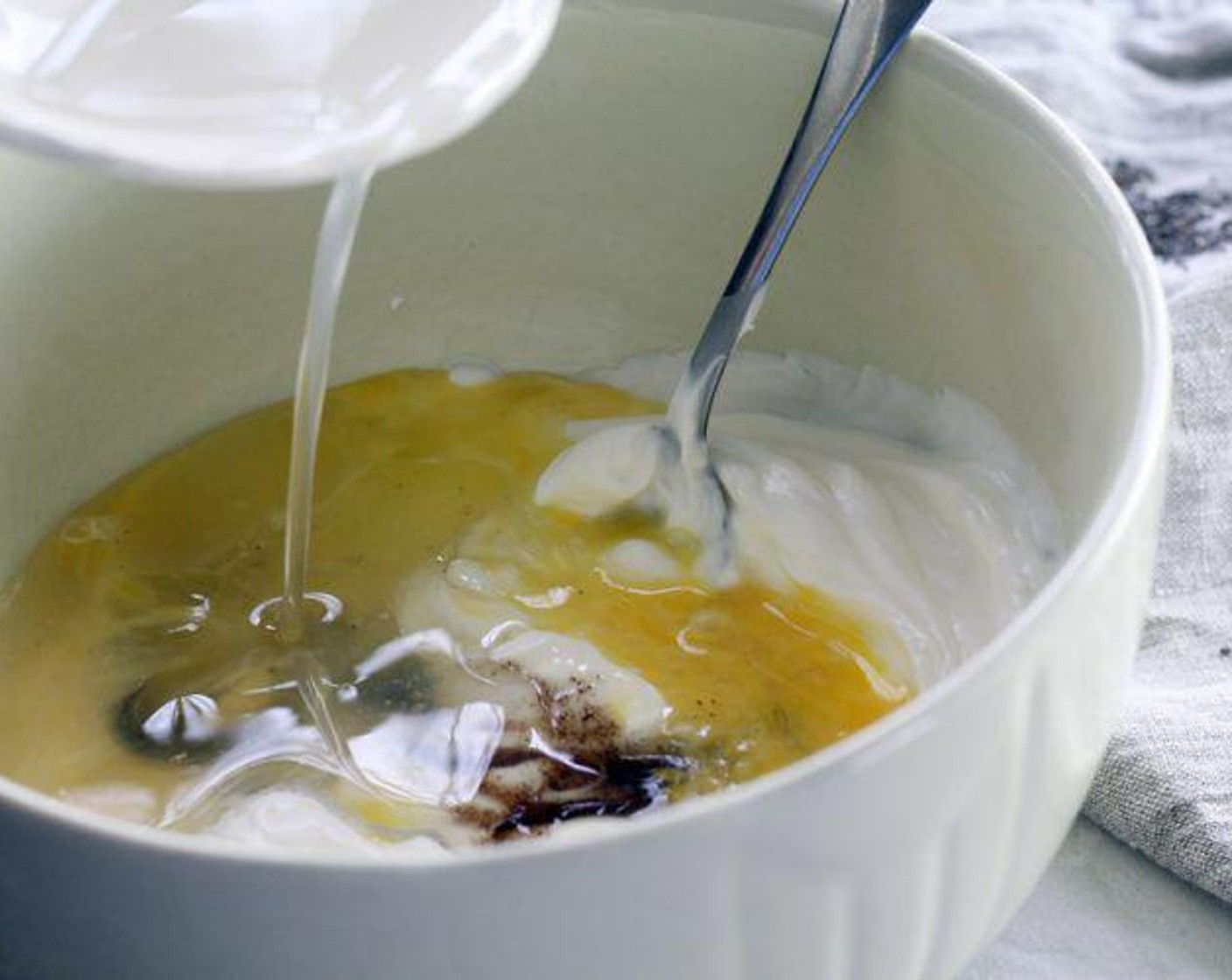 step 4 In a medium-sized bowl, whisk the Sour Cream (1 cup), Farmhouse Eggs® Large Brown Egg (1), 1 Tbsp Lemon Juice, Vanilla Bean Paste (1/2 Tbsp), and melted lard until creamy.