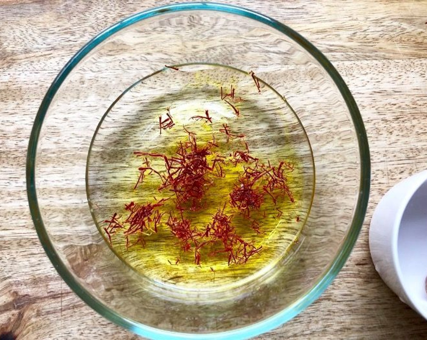 step 1 Place the Dry White Wine (1/2 cup) and Saffron Threads (1/4 tsp) in a small bowl. Set aside to allow the threads to soften.