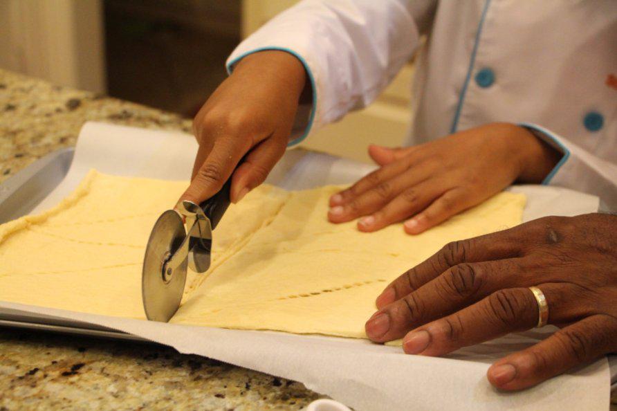 Step 5 of Apple Pie Bites Recipe: Unroll the Crescent Roll Dough (8 ounce) and separate into 8 triangles on a baking sheet lined with parchment paper.