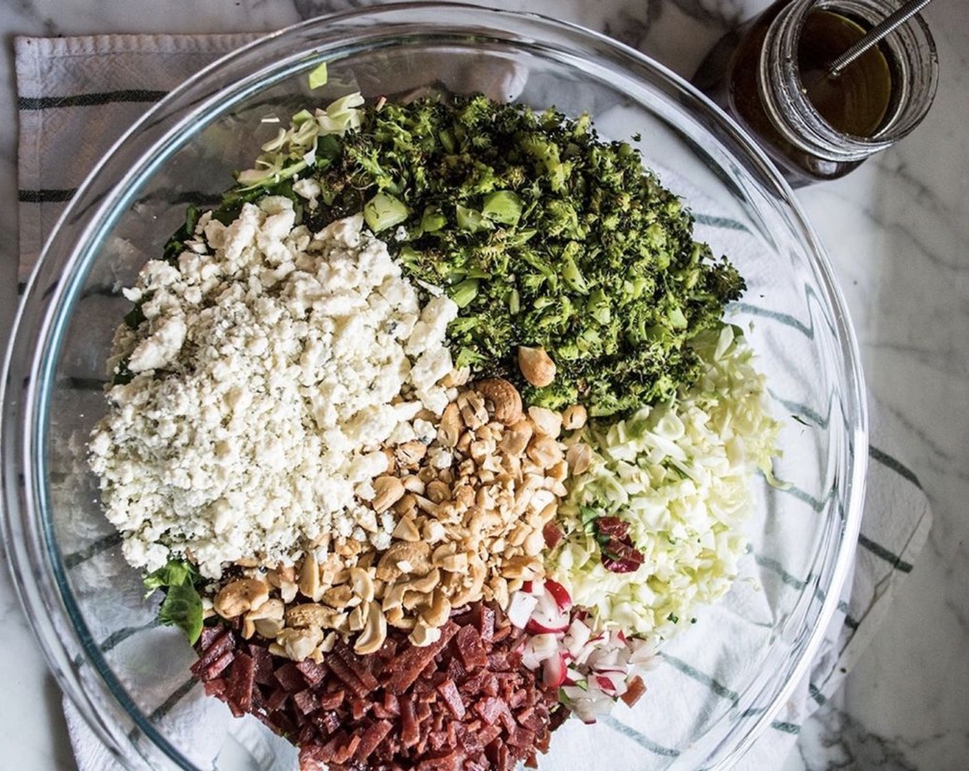 step 5 Add Salad Greens (6 cups), Green Cabbage (2 cups), and Radish (1 bunch) to a large bowl. Then top with Turkey Bacon (8 slices) and broccoli, along with Unsalted Cashews (3/4 cup) and Blue Cheese (3/4 cup). Toss or stir until all ingredients are well-mixed.