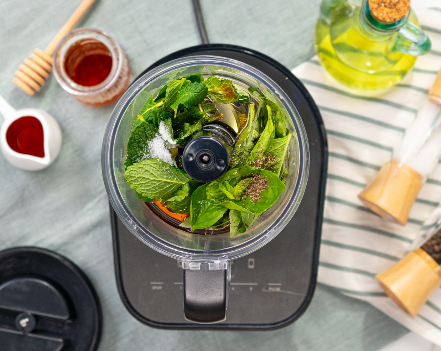 step 2 In a food processor, add Fresh Mint Leaves (1/4 cup), Fresh Basil Leaf (1/4 cup), Extra-Virgin Olive Oil (1/2 cup), Red Wine Vinegar (3 Tbsp), Honey (1 tsp), Salt (1/4 tsp), and Ground Black Pepper (1/8 tsp). Pulse until everything combines.