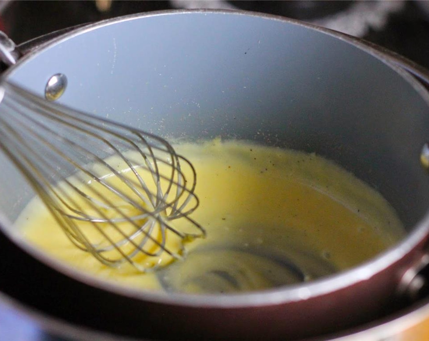 step 4 Place the egg yolk mixture in a double boiler, or a pan or bowl that has been placed over a larger pan of hot water. Turn the burner to medium-high and heat.