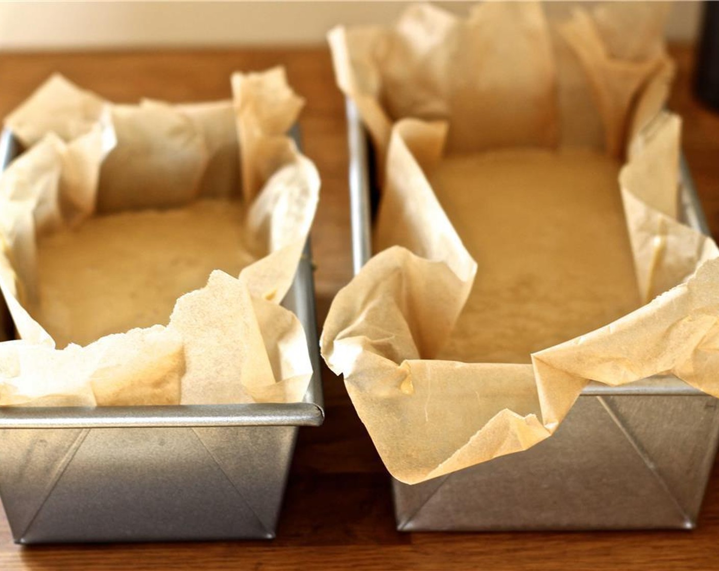 step 7 Divide the batter between the loaf pans and place in the oven to bake for about an hour, or until a toothpick inserted into the center of the cake comes out clean.