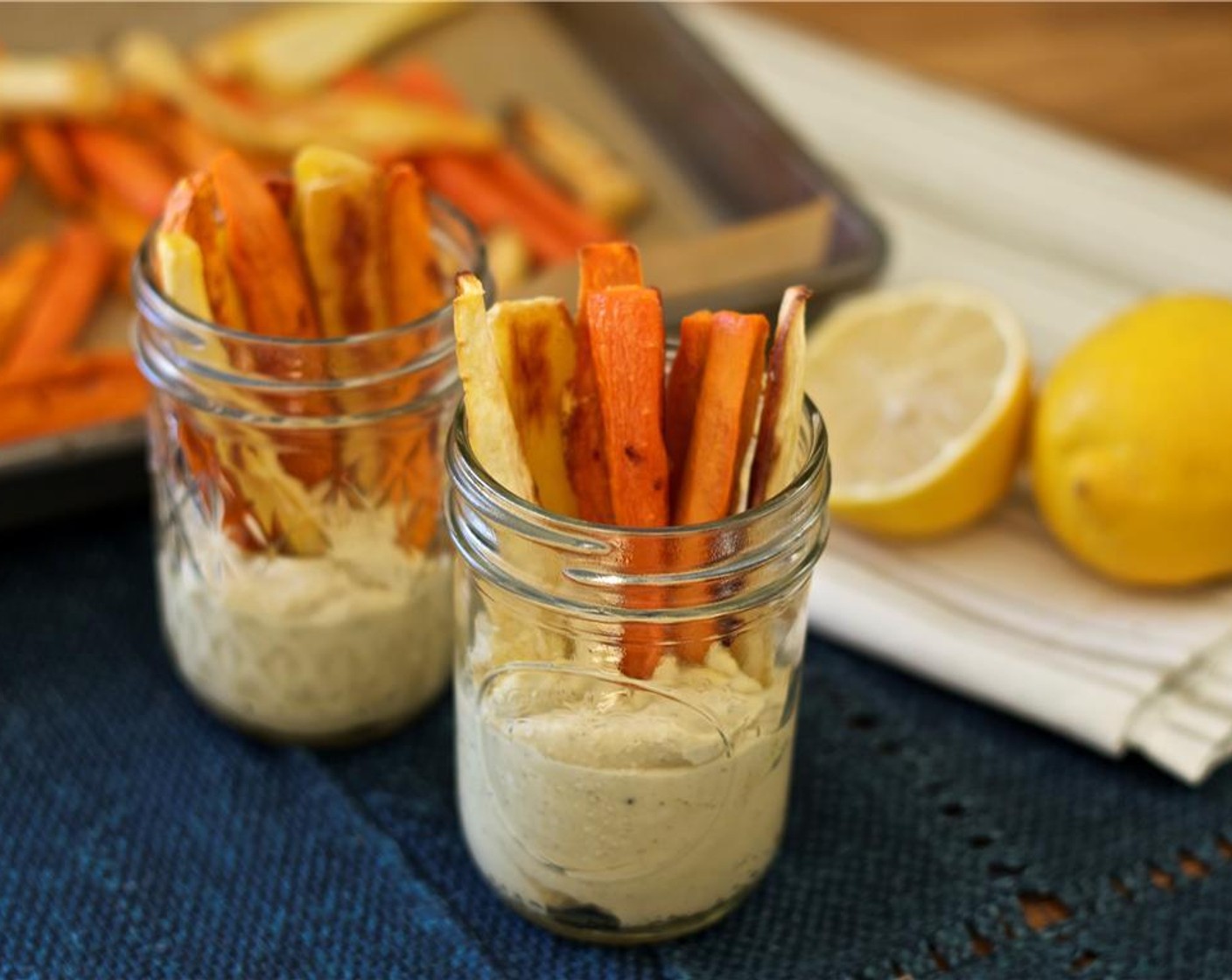 step 6 Spoon 3 tbsp of the hummus into bottom of eight 2-oz shot glasses or small glasses; divide roasted vegetables among glasses, with ends dipped in hummus.