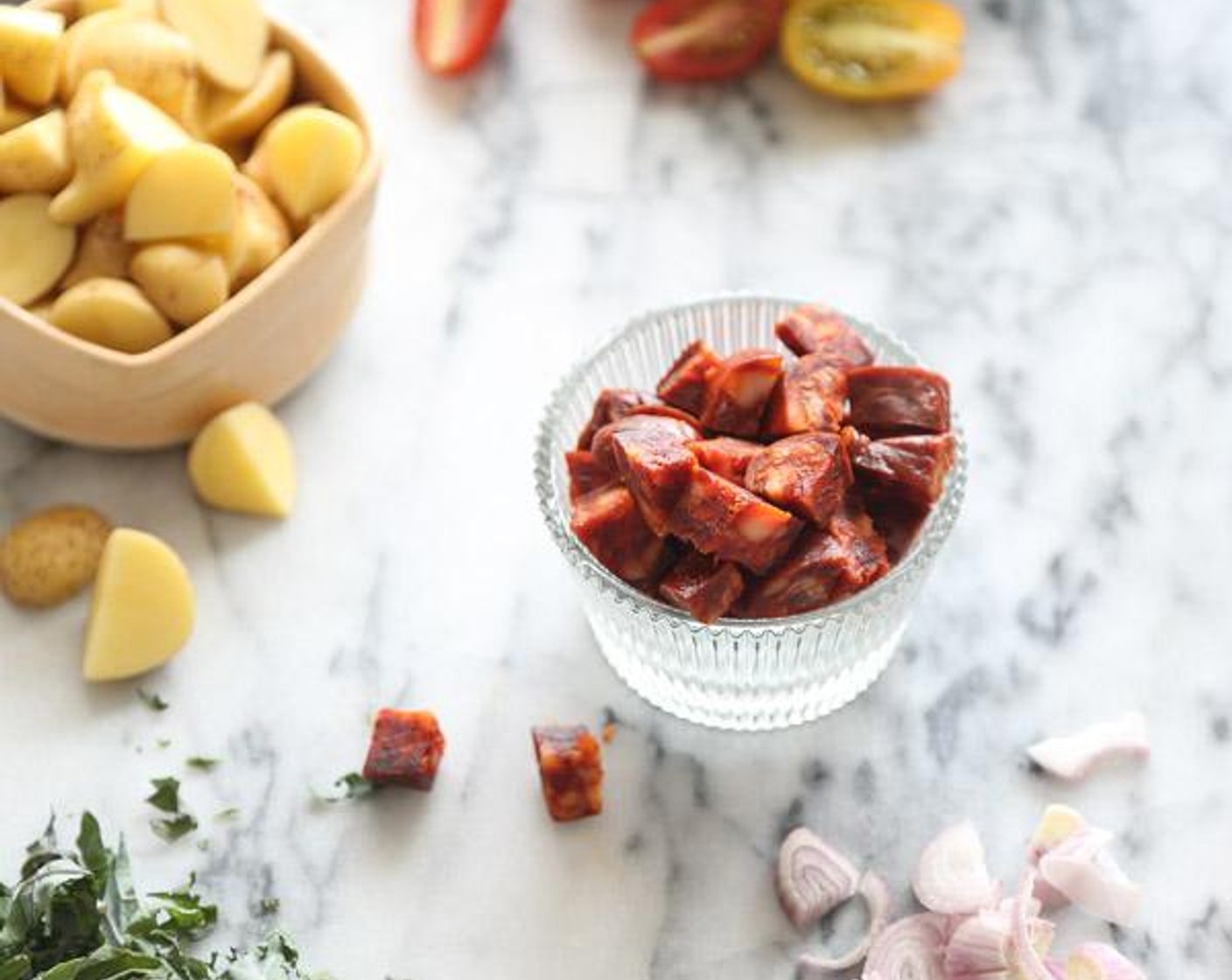 step 2 In a large lidded Dutch oven or saucepan, heat the Olive Oil (1 Tbsp). Sauté the Spanish Chorizo (4 oz), Shallots (2), and Baby Yukon Gold Potatoes (2 1/2 cups) over medium-high heat.