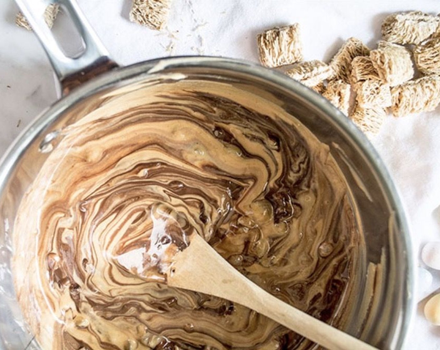 step 1 Add Dark Chocolate Chips (1 cup) and Creamy Peanut Butter (2/3 cup) to a medium saucepan and cook over low heat, stirring frequently until chocolate and peanut butter are melted. You can also do this in a microwave-safe bowl, heating chocolate and peanut butter together for 30 seconds, remove and stir, then continue heating in 20-second intervals, stirring in between until the chocolate is melted and a smooth consistency is reached.