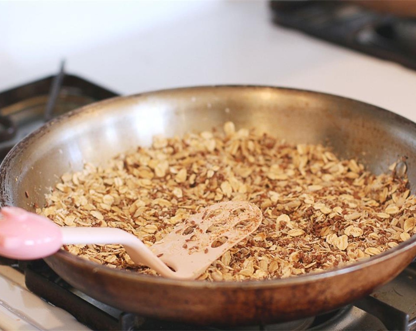 step 3 Then drizzle the Honey (2 Tbsp) over it, mix again, and press it into a single layer in the pan.