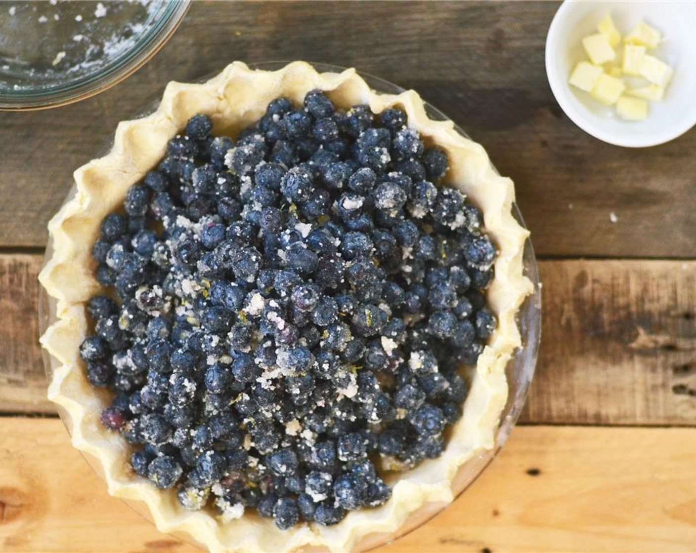 step 12 Remove pie crust from freezer and pour blueberry filling into pie crust. Dot filling with pieces of Unsalted Butter (1 Tbsp).