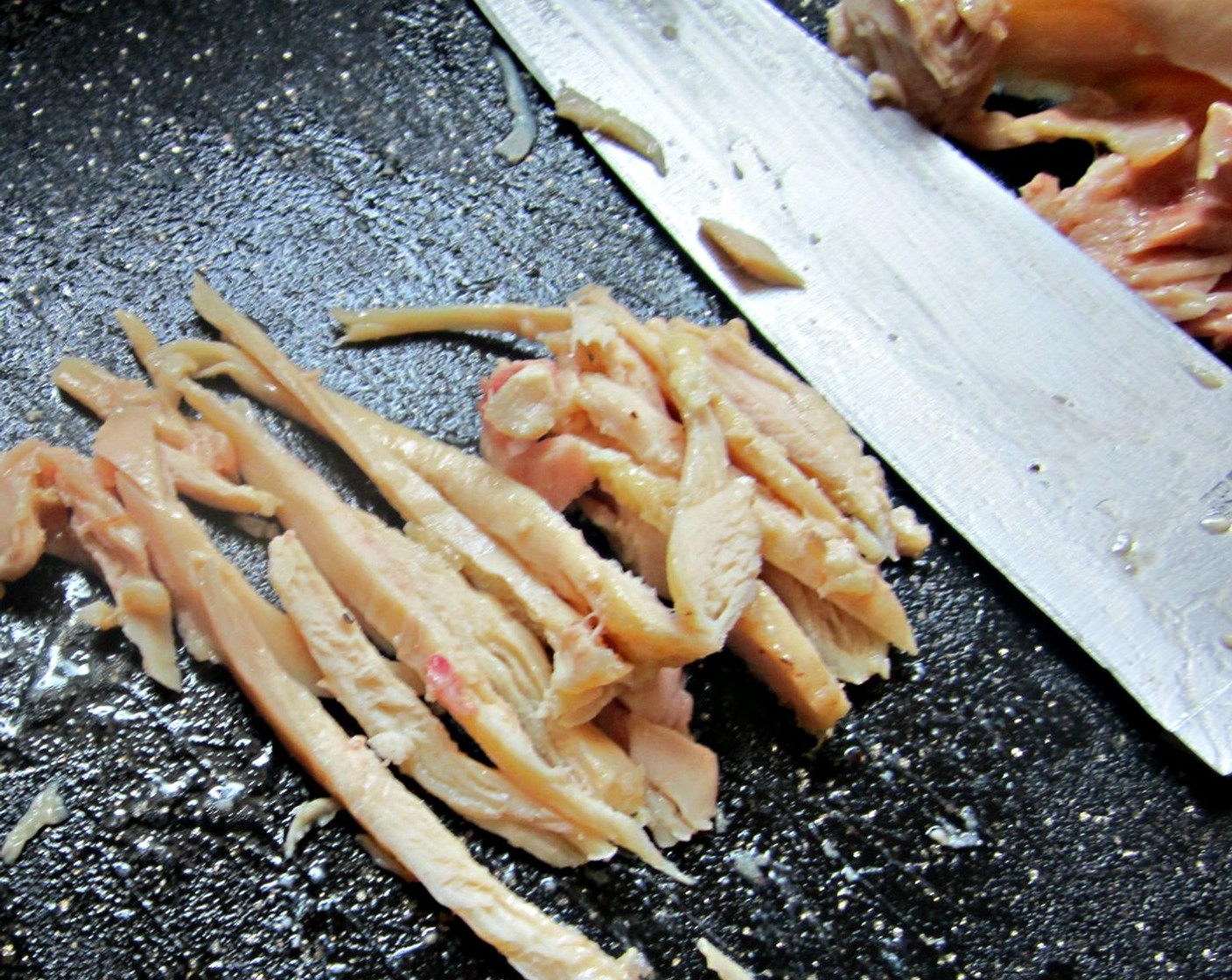 step 8 Once the veggies are cooked add them to this mixture. Take your chicken out of the freezer and remove the meat from the bones. You have the option to shred the chicken, tasty but tedious or cheat like I did and cut the chicken into fine slices.