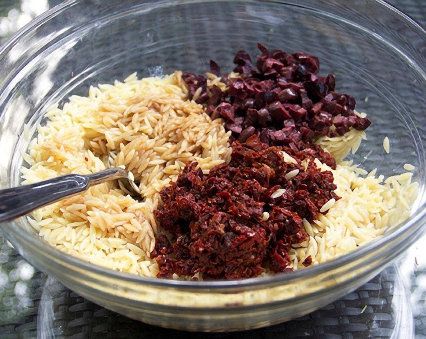 step 2 Add Extra-Virgin Olive Oil (1/3 cup), Balsamic Vinegar (1/3 cup), Sun-Dried Tomatoes (2/3 cup), and Kalamata Olives (2/3 cup). Stir to combine with the cooked orzo.