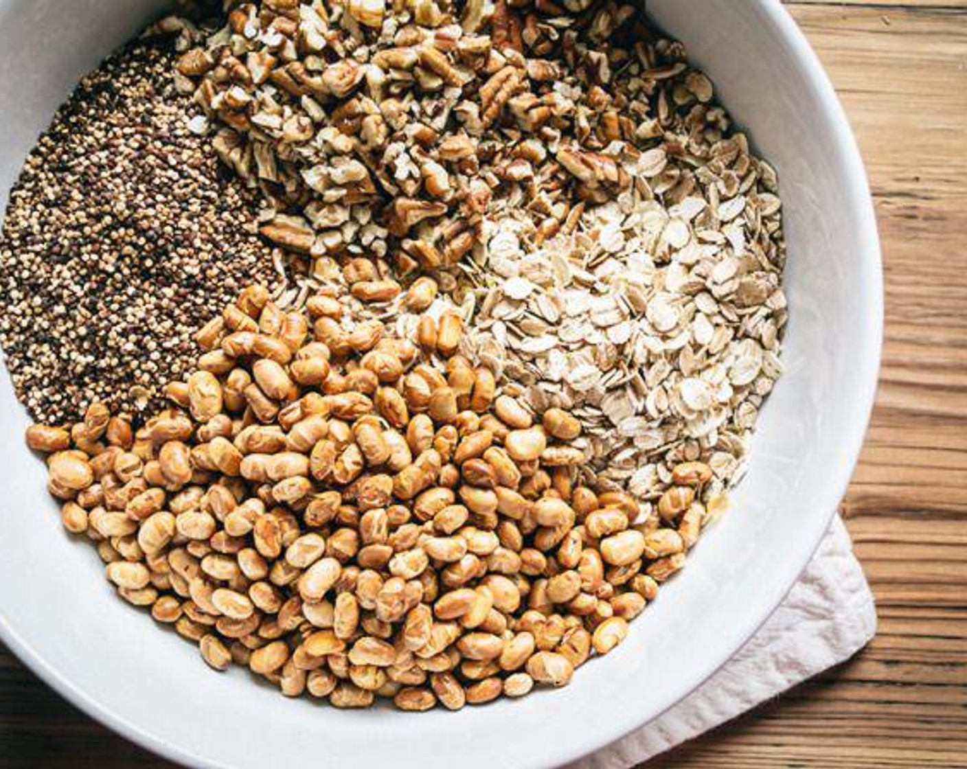 step 3 In a large bowl, add Oats (3 cups), Chopped Pecans (3/4 cup), Organic Soy Nuts (1 cup), and toasted quinoa, toss with hands to mix well, then set aside.