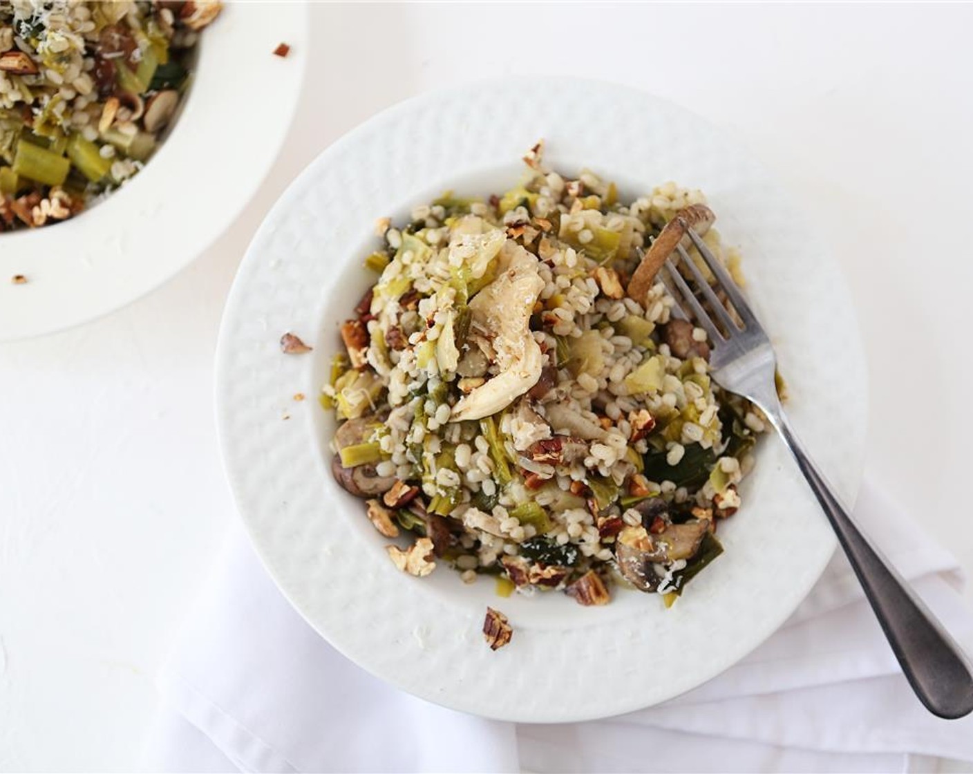 step 10 Season with Kosher Salt (to taste) and Ground Black Pepper (to taste). Divide barley onto two plates, and top with walnuts and Parmesan Cheese (2/3 cup). Enjoy!