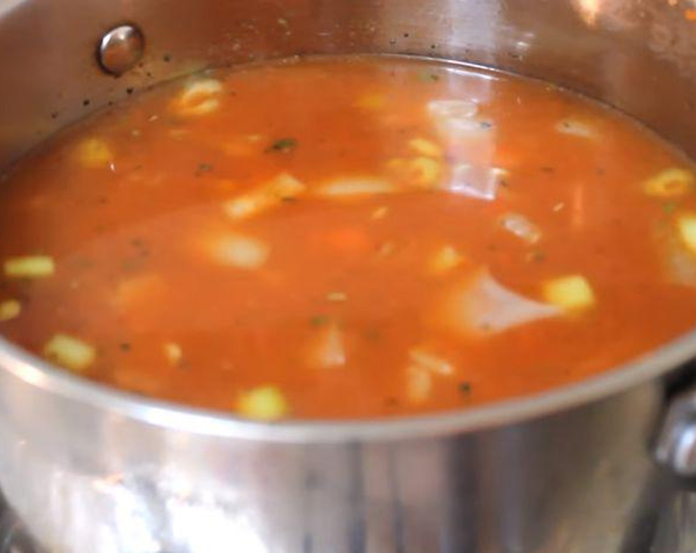 step 2 Add the Dried Basil (1/2 tsp), and Dried Parsley (1/2 tsp). Mix. Add the Vegetable Broth (18 fl oz), Water (2 cups), Lentils (1 cup), and Canned Crushed Tomatoes (1 2/3 cups). Bring to a boil.