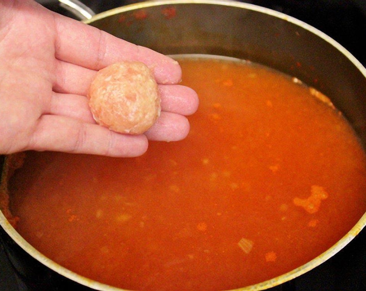 step 7 Using damp hands, form the ground meat mixture into approximately 1/2 tablespoon meatballs and drop into simmering soup.