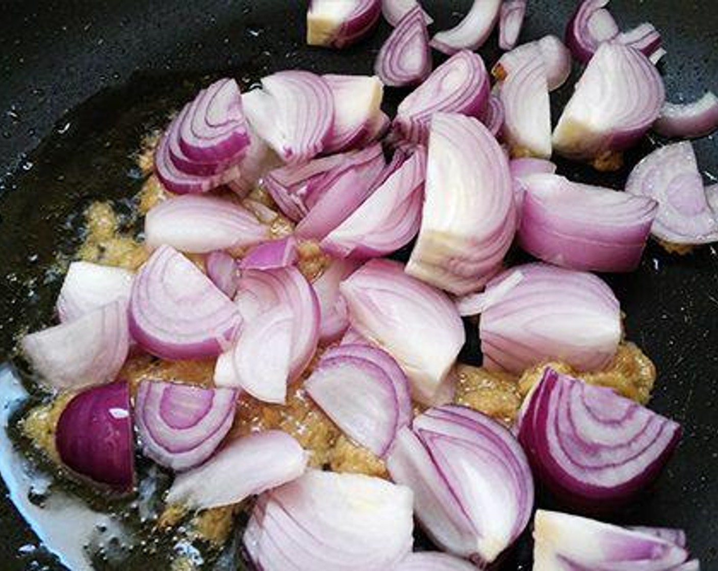 step 5 For the gravy: To a pan pour Oil (1 Tbsp) and add Ginger Garlic Paste (1 Tbsp). Saute for two to three minutes and add sliced onion.