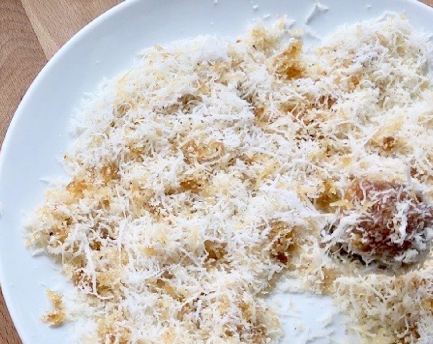 step 8 Then, roll it in the aromatic coconut mixture to form into a ball. Toss well to evenly coat the nian gao with the grated coconut.