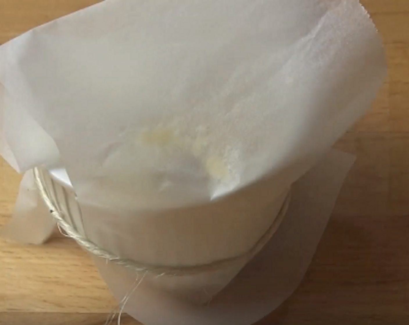 step 5 Divide the batter between the four pudding bowls. For each bowl, put a pleated piece of baking paper over the top and tie with string around the base. Wrap the bowl with tin foil.