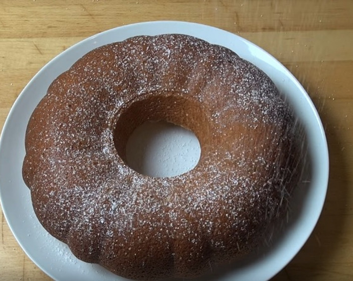 step 7 Flip cake onto serving platter and let cool completely. Sprinkle with Powdered Confectioners Sugar (to taste).