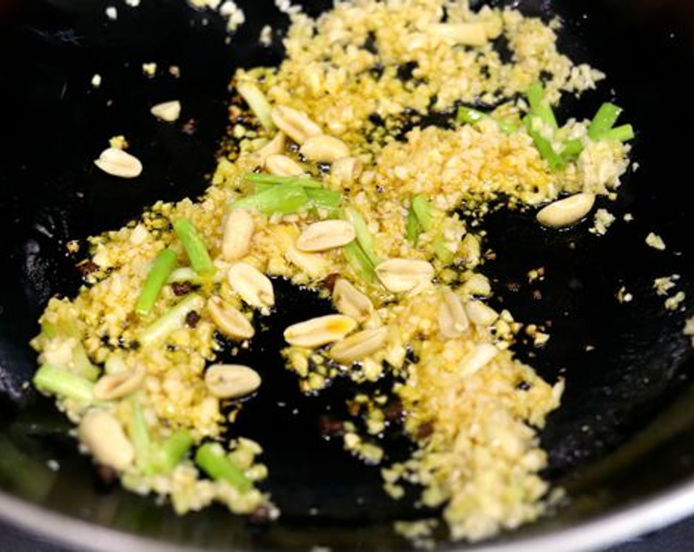 step 10 Add in the Dry Roasted, Unsalted Peanuts (1 Tbsp) and Sichuan Peppercorns (1/2 tsp). Let the peanuts brown in the wok for about 20 seconds before tossing again.