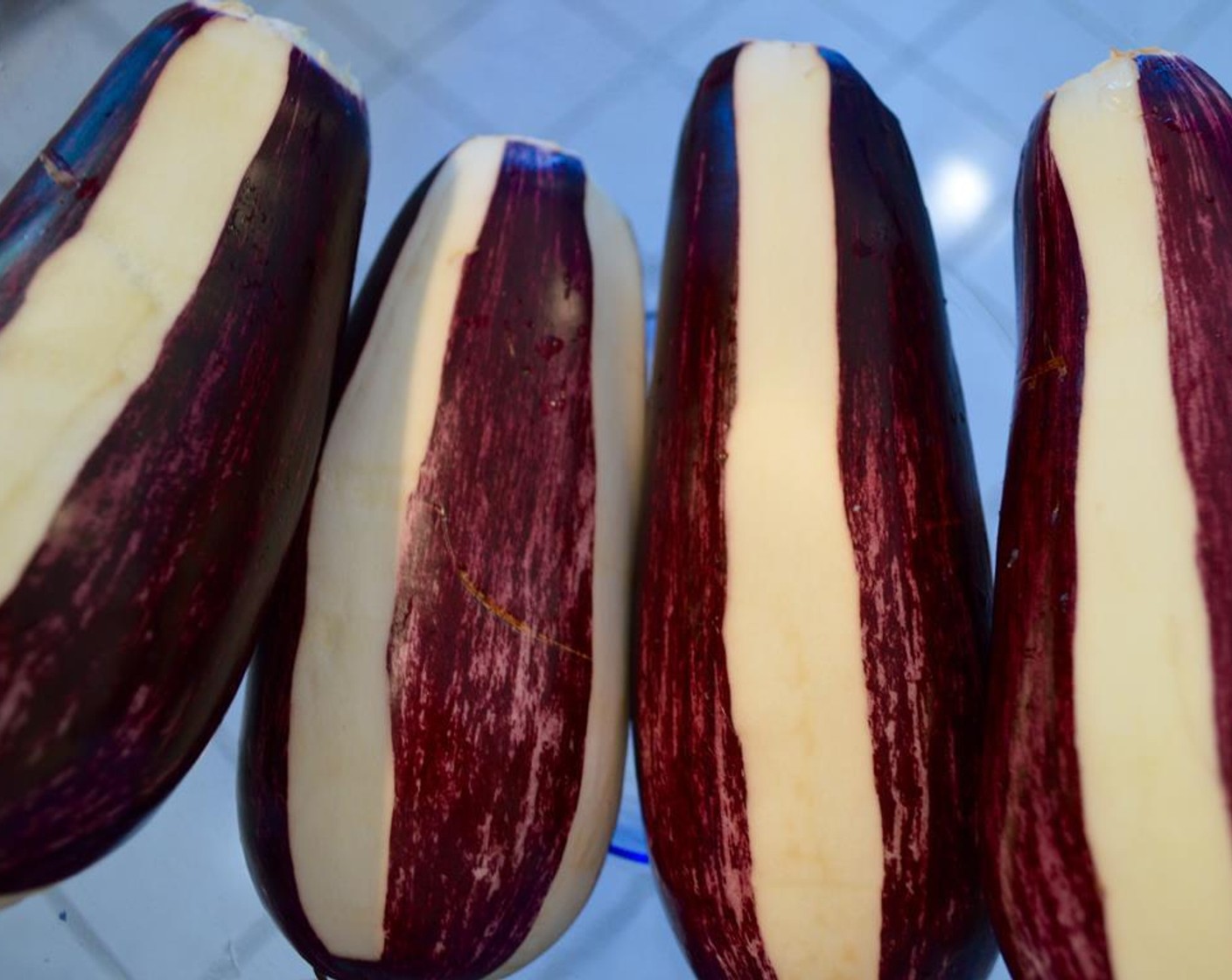 step 3 Peel each Eggplants (4) to black and white by removing stems and using a vegetable peeler. Place eggplants in a bowl of salted water for 20-30 minutes to remove bitterness. Then, remove eggplants from salt-water. Dry them with a clean kitchen towel.