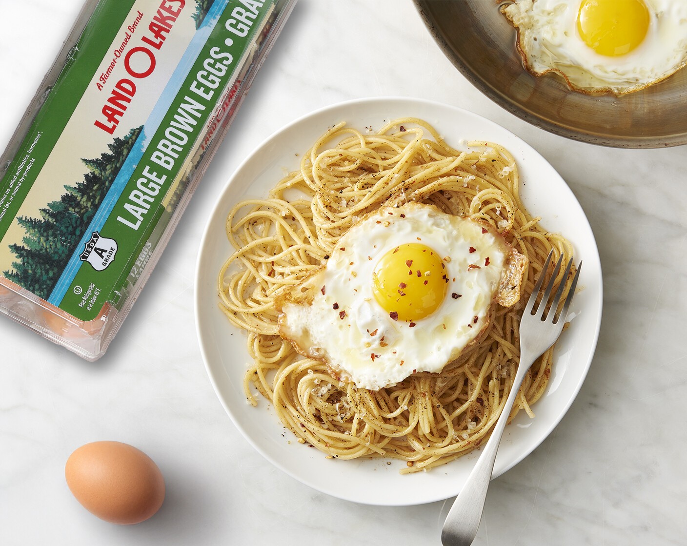 step 8 Transfer warm pasta to serving plate; top with fried eggs. Serve immediately topped with additional Galbani Parmesan Cheese (to taste) and Crushed Red Pepper Flakes (to taste) as desired.