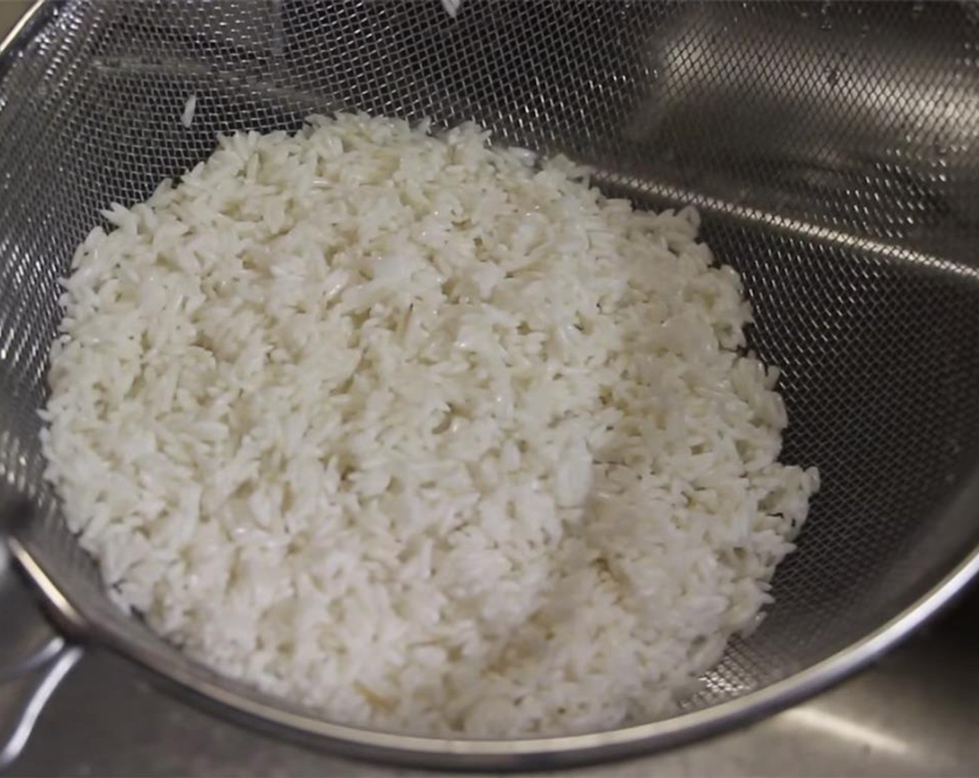 step 2 Wash and rinse the Long Grain White Rice (2 cups) a couple of times to remove impurities. Rinse it under running water through a strainer, using your fingers to let the water run through the uncooked rice.